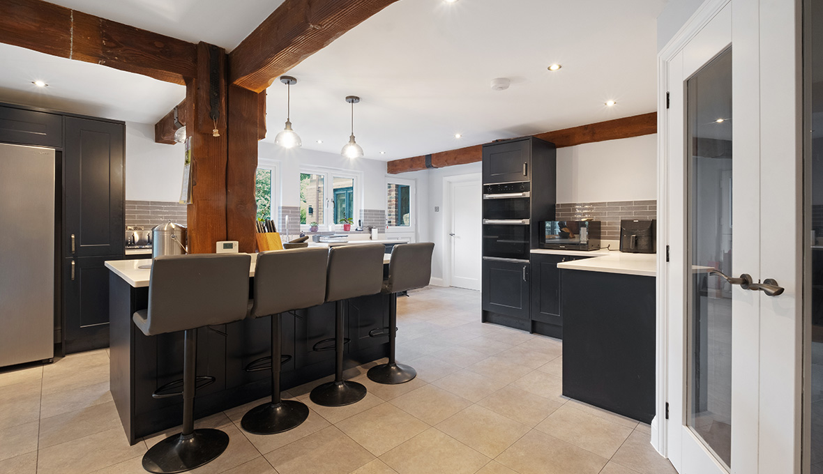 Open plan kitchen with exposed beams
